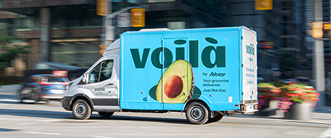 Picture of a delivery truck of Voila with the text written 'Voila by Sobeys. Your groceries delivered. Just like that.'