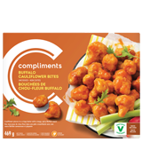 orange box with buffalo cauliflower bites beside celery sticks on yellow and white napkins 