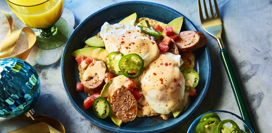 Sunny side up fried eggs on a corn tortilla smothered in hollandaise, guacamole and topped with cooked chorizo, tomatoes and sliced jalapeno pepper. 