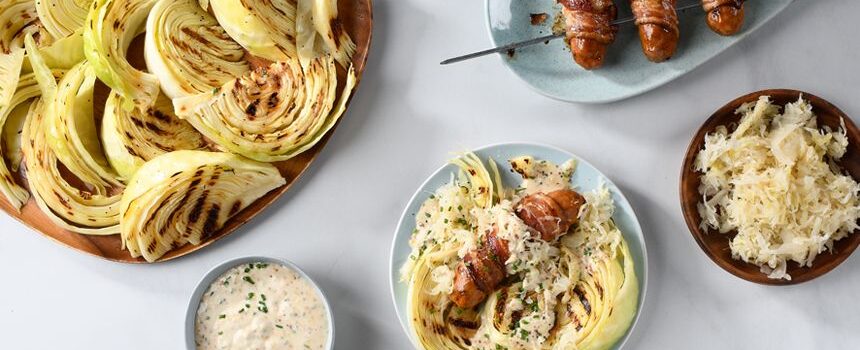 Bacon Wrapped Sausages with Grilled Cabbage and Sauerkraut Slaw