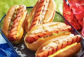 Metal mesh basket with prepared hot dogs