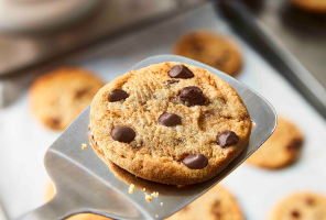 freshly baked chocolate chip cookie on metal spatula