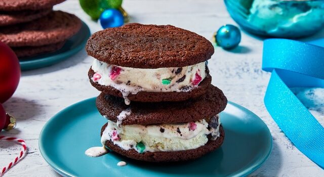 Two ice cream sandwiches stacked on top of each other on a blue plate