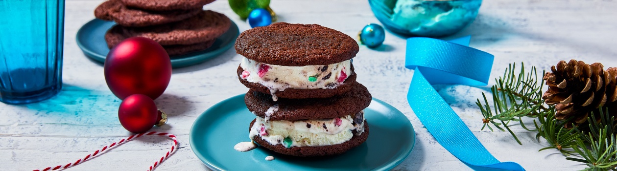 Two ice cream sandwiches stacked on top of each other on a blue plate